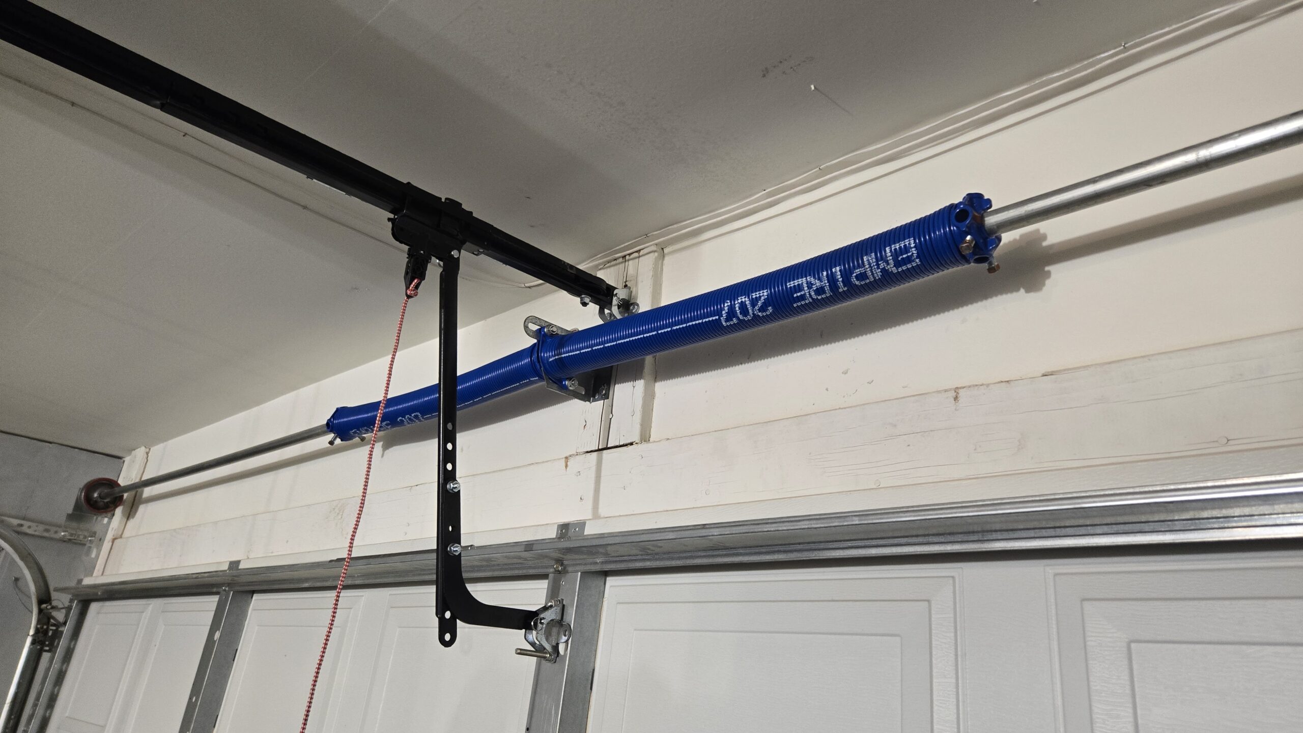 Replacement torsion springs installed above a residential garage door
