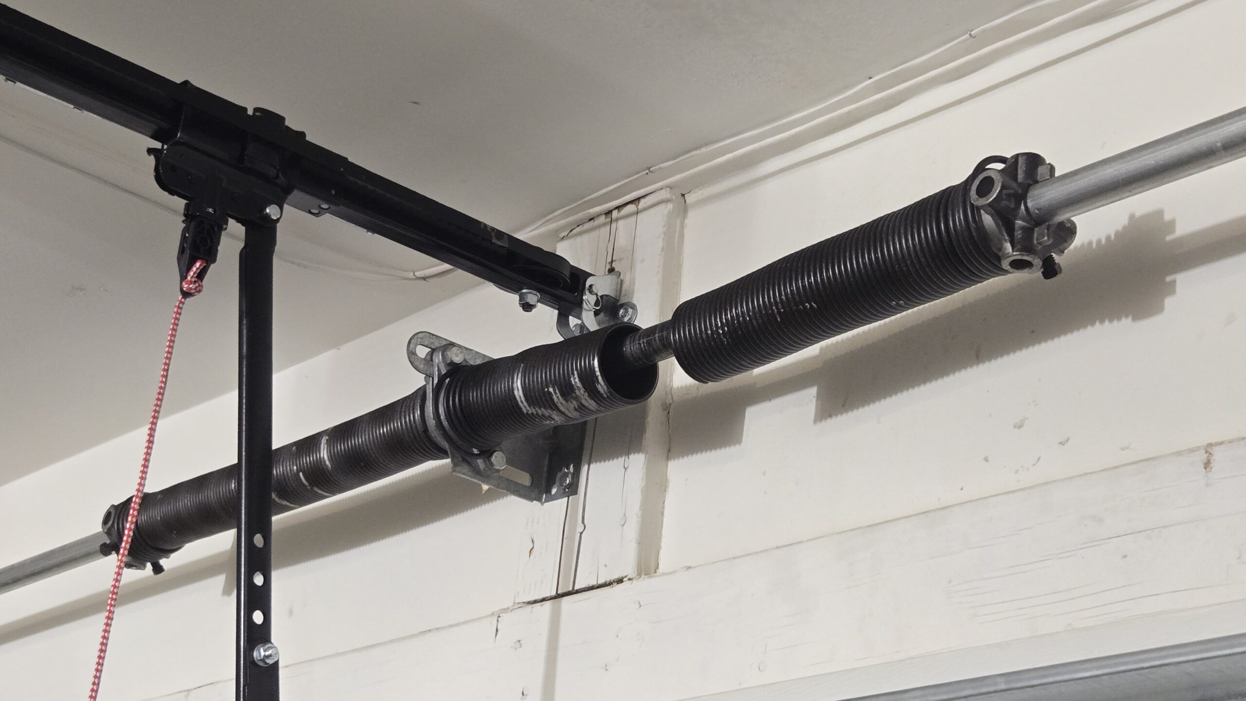 Broken garage door spring in Las Vegas before replacement by Empire Garage Door