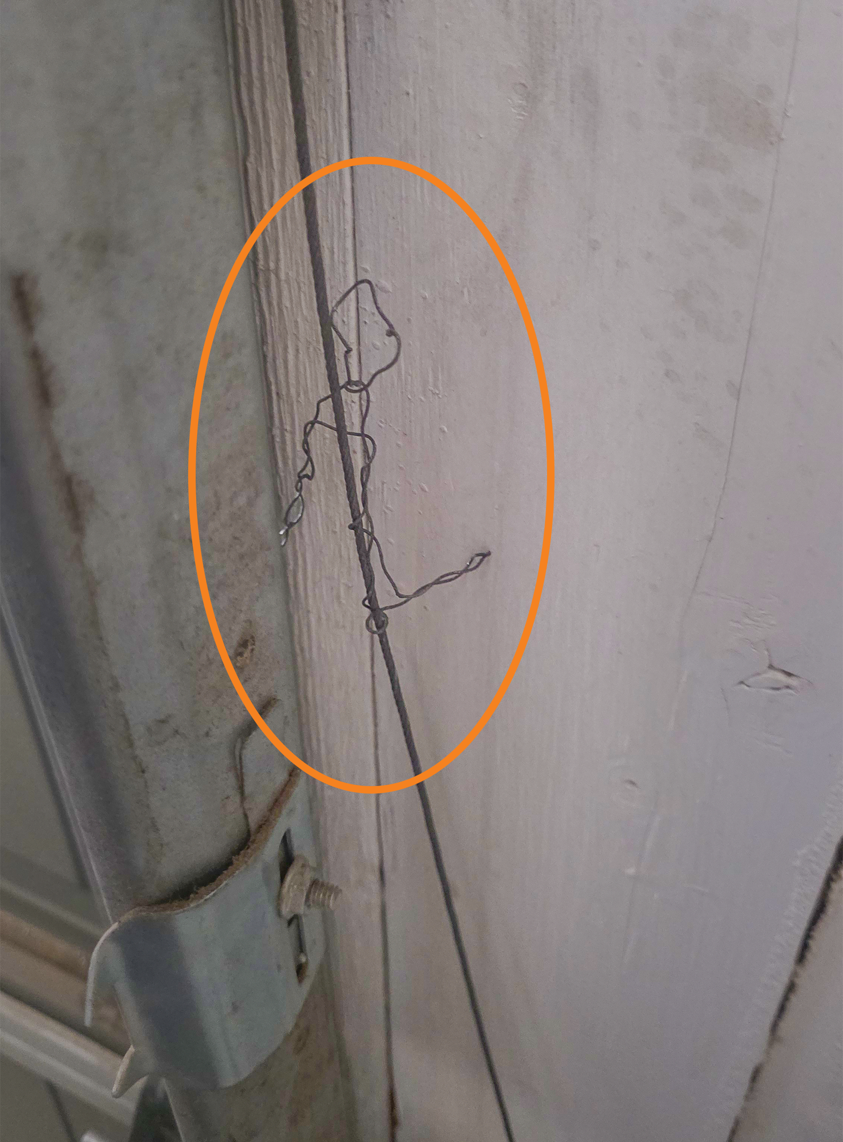 Frayed garage door cable safety concern near the bottom bracket area