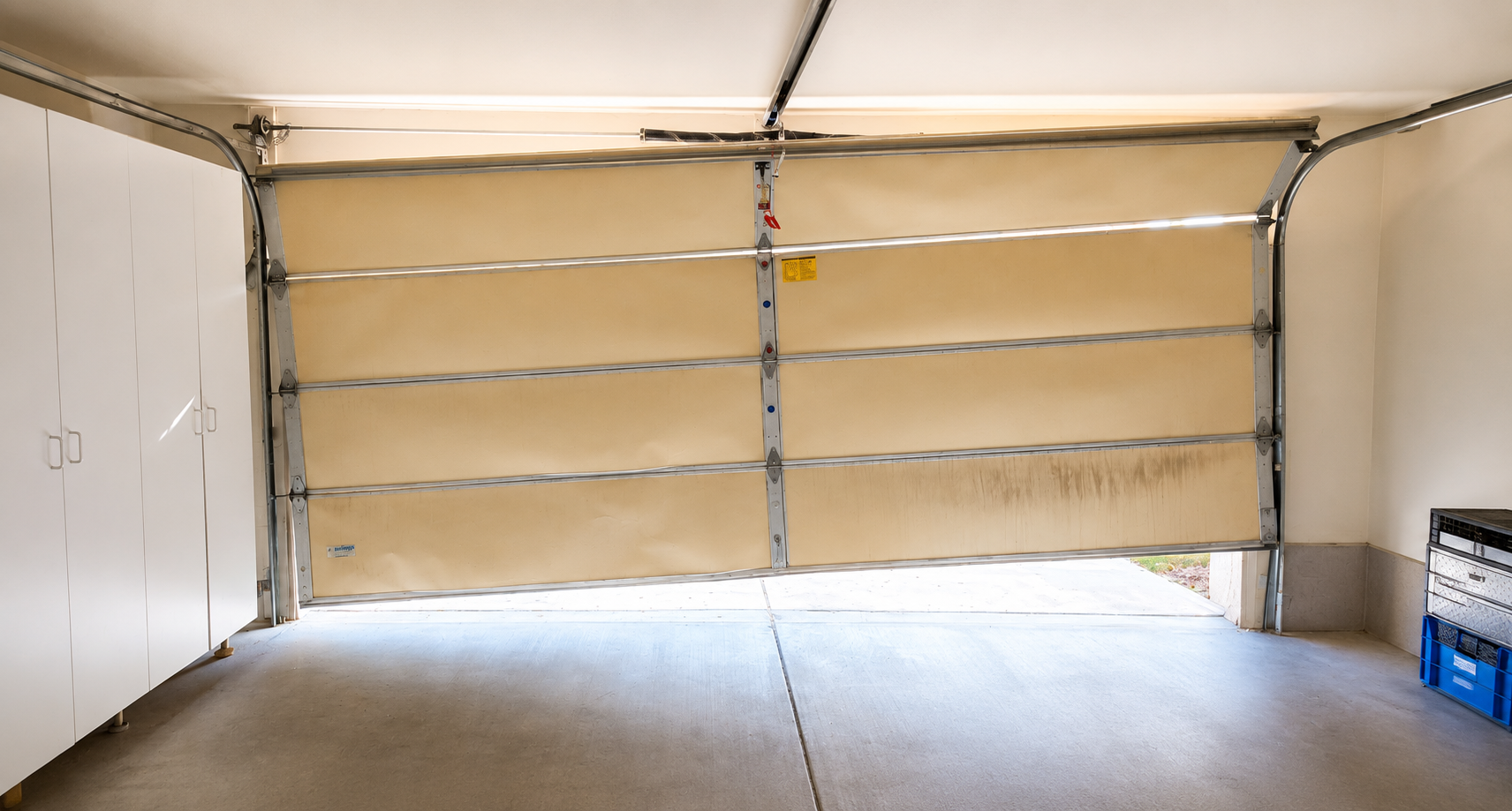 Crooked garage door inside a Las Vegas garage showing unsafe garage door movement