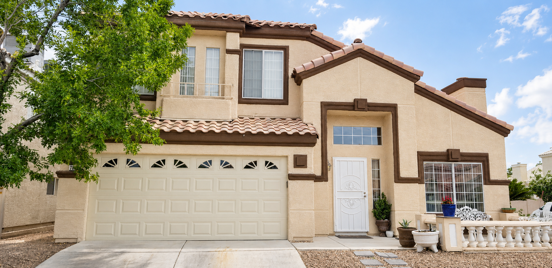 Residential garage door service at a Las Vegas home exterior by Empire Garage Door