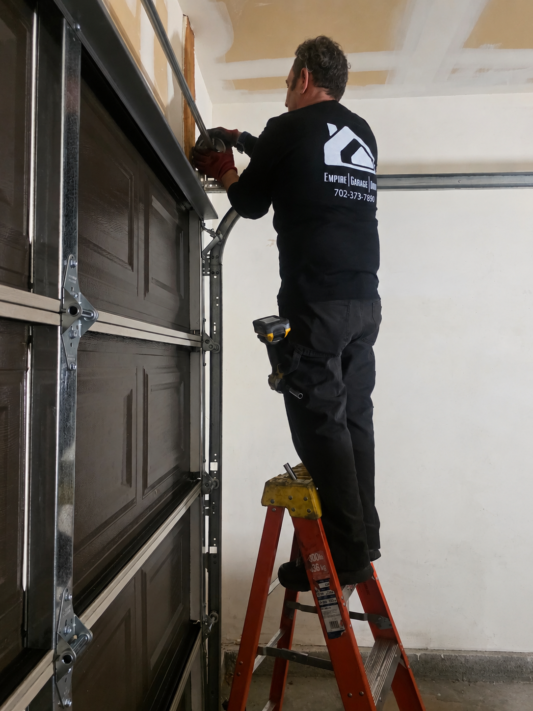 Empire Garage Door technician servicing residential garage door hardware