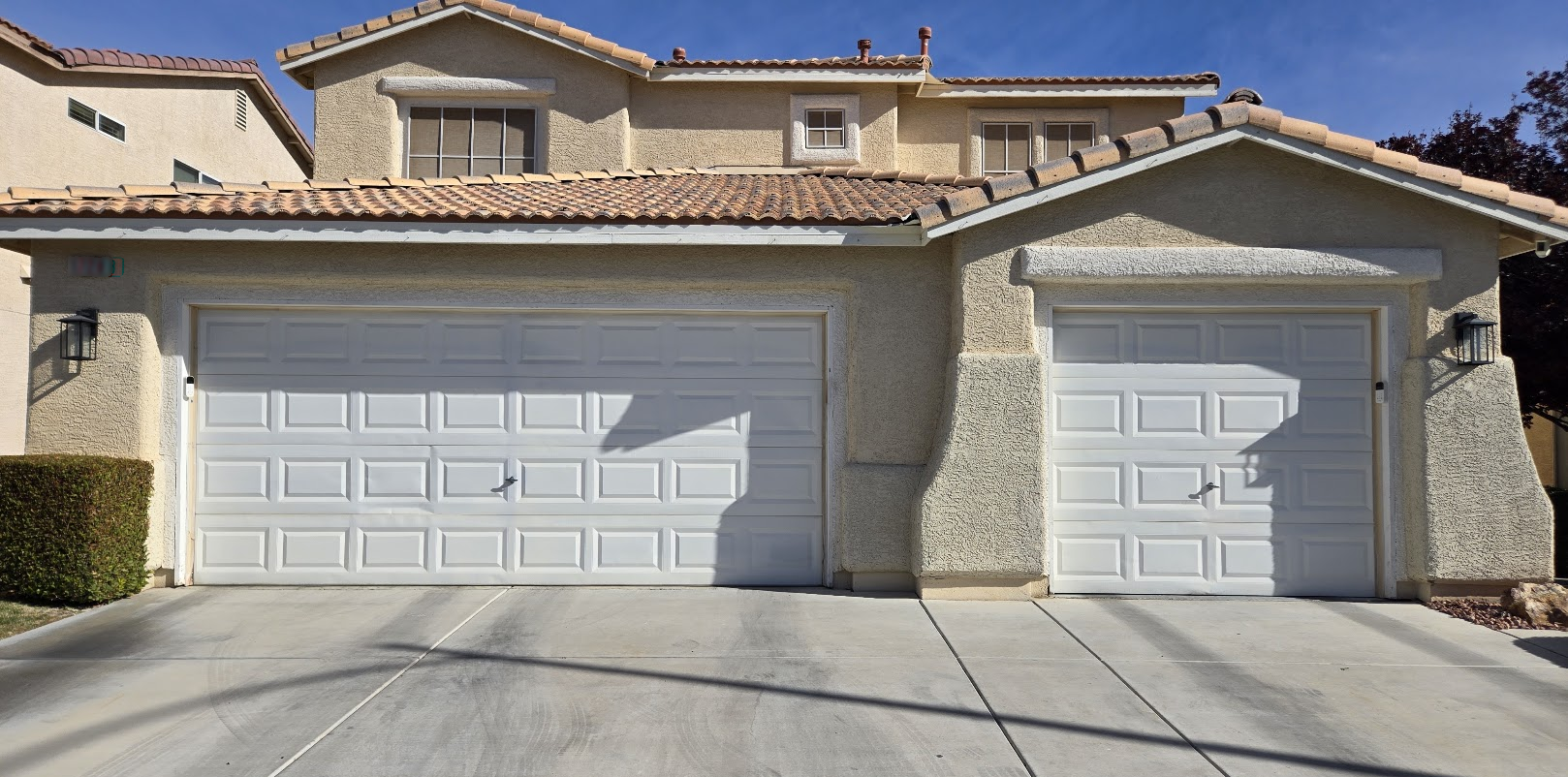 Two white garage doors on a stucco home in Spring Valley, Las Vegas